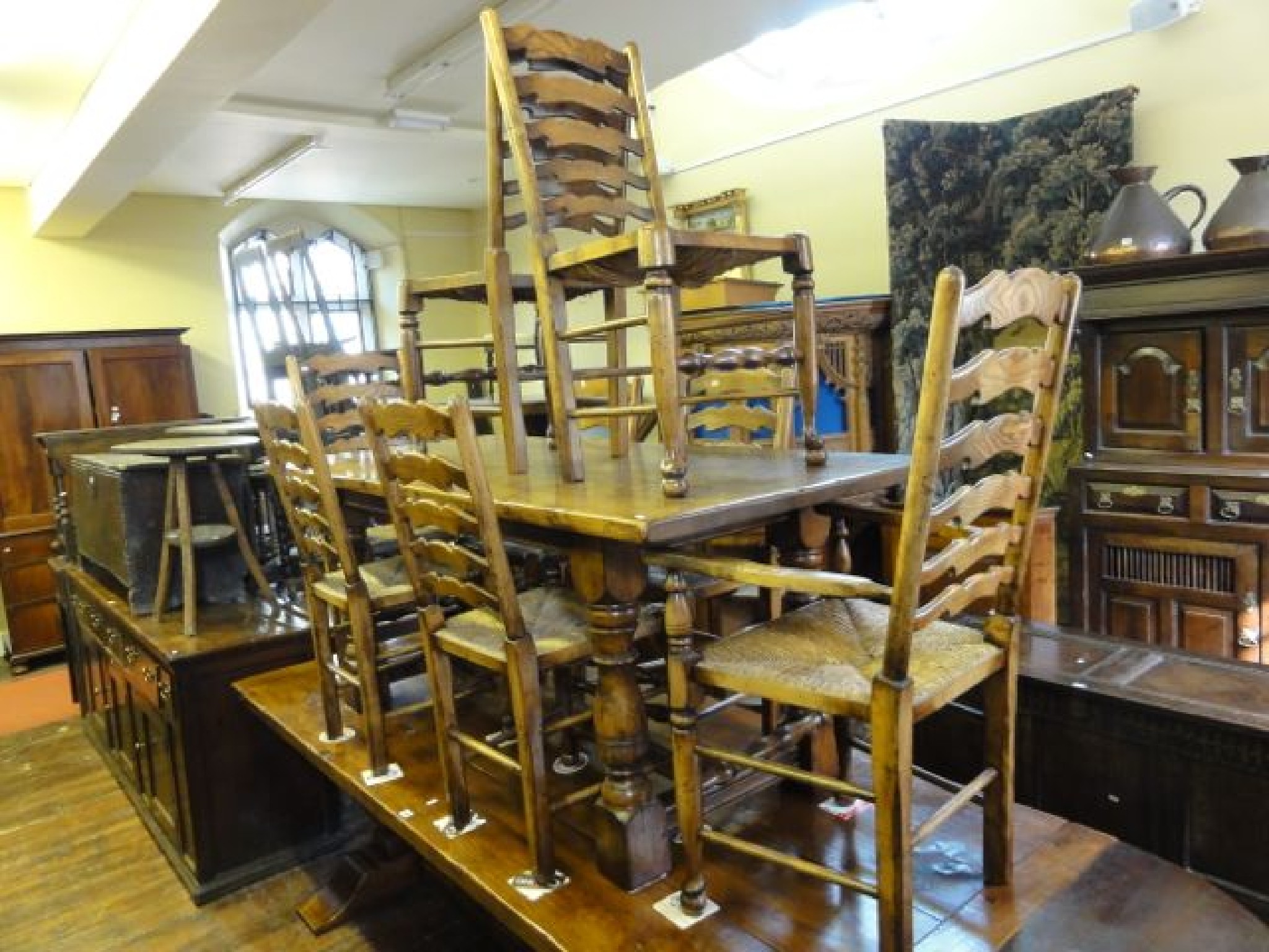 Appraisal: An oak refectory table in the old English style raised