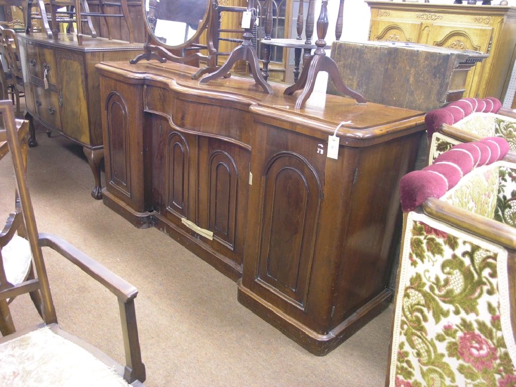 Appraisal: A Victorian mahogany sideboard serpentine-fronted central section with single drawer