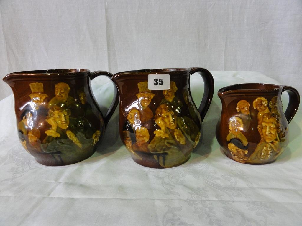 Appraisal: A pair of Royal Doulton Kingsware jugs with relief moulded