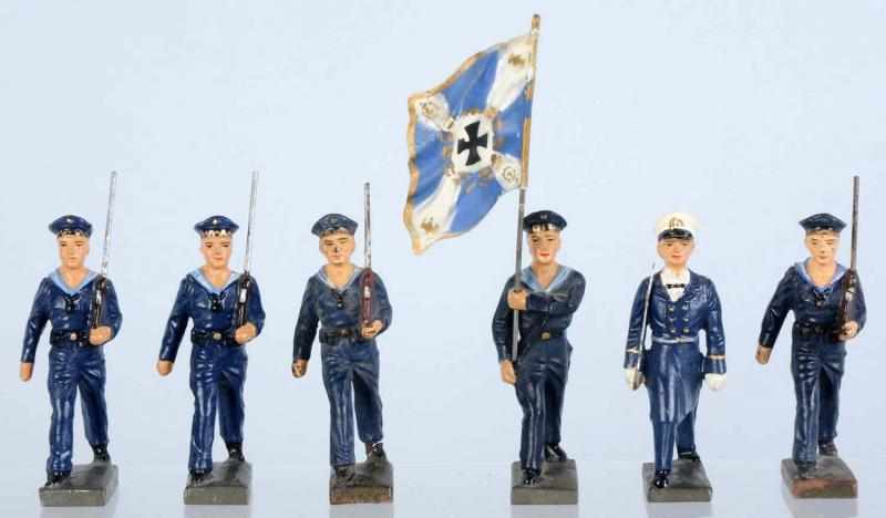 Appraisal: Lineol Sailors Marching Group in Blue Uniforms Includes six sailors