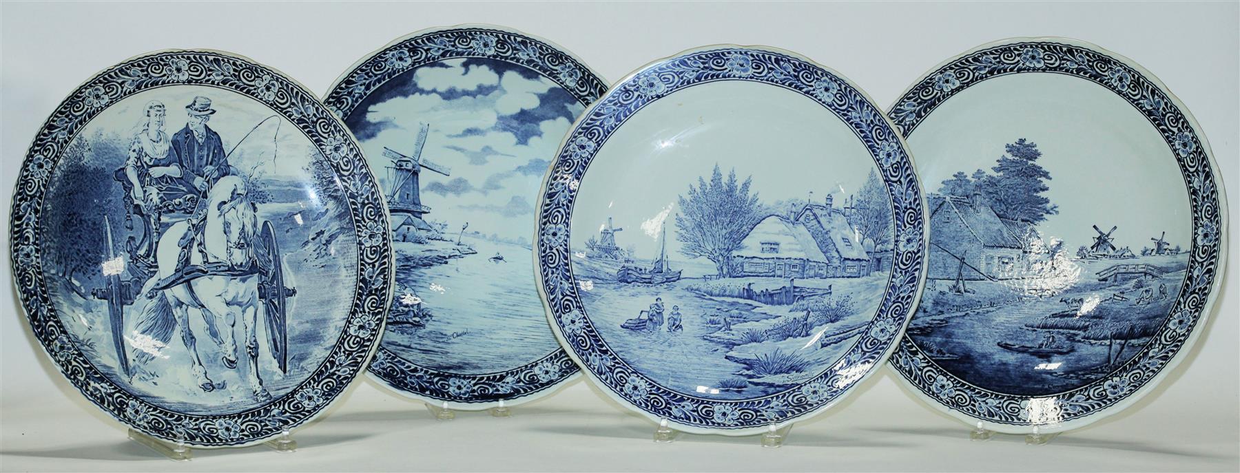 Appraisal: FOUR DELFT CHARGERS European mid th century Floral borders with