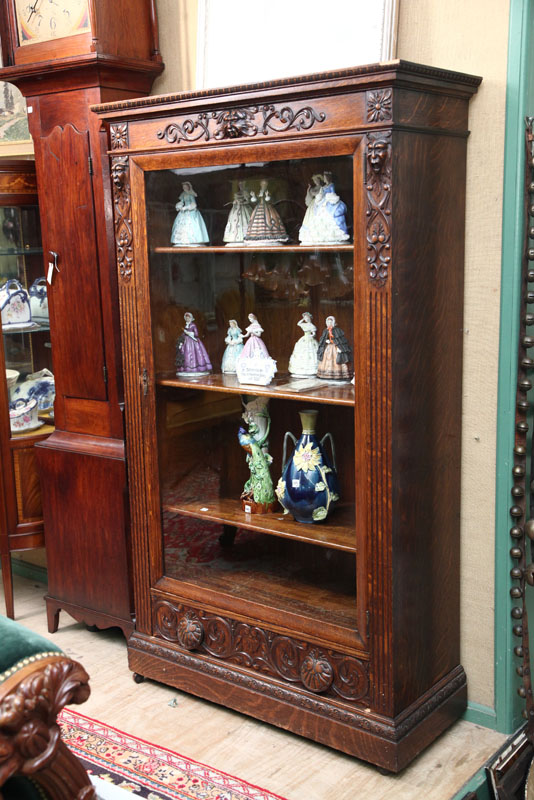 Appraisal: BOOKCASE Oak with carved cornice faces scrollwork shell and floral