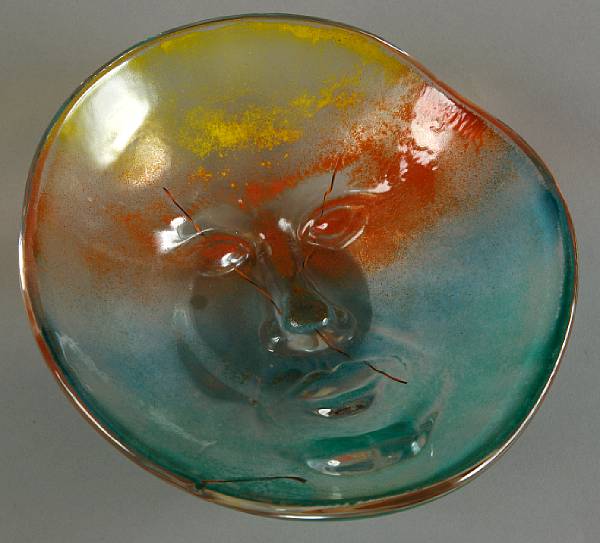 Appraisal: A Kosta Boda iridescent glass bowl with facial ornament signed