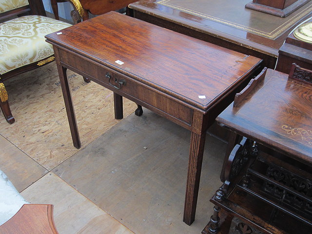 Appraisal: A GEORGIAN MAHOGANY FOLDOVER CARD TABLE the single frieze drawer