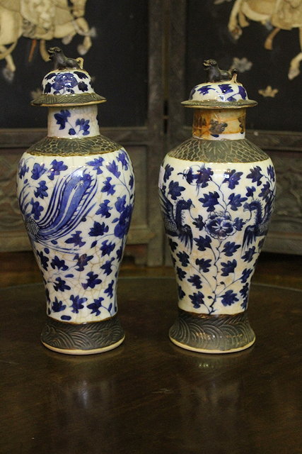 Appraisal: A PAIR OF CHINESE CRACKLEWARE VASES and covers decorated dragons