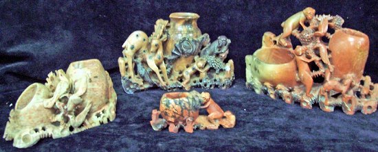 Appraisal: An Oriental soapstone spill vase modelled with clambering monkeys together