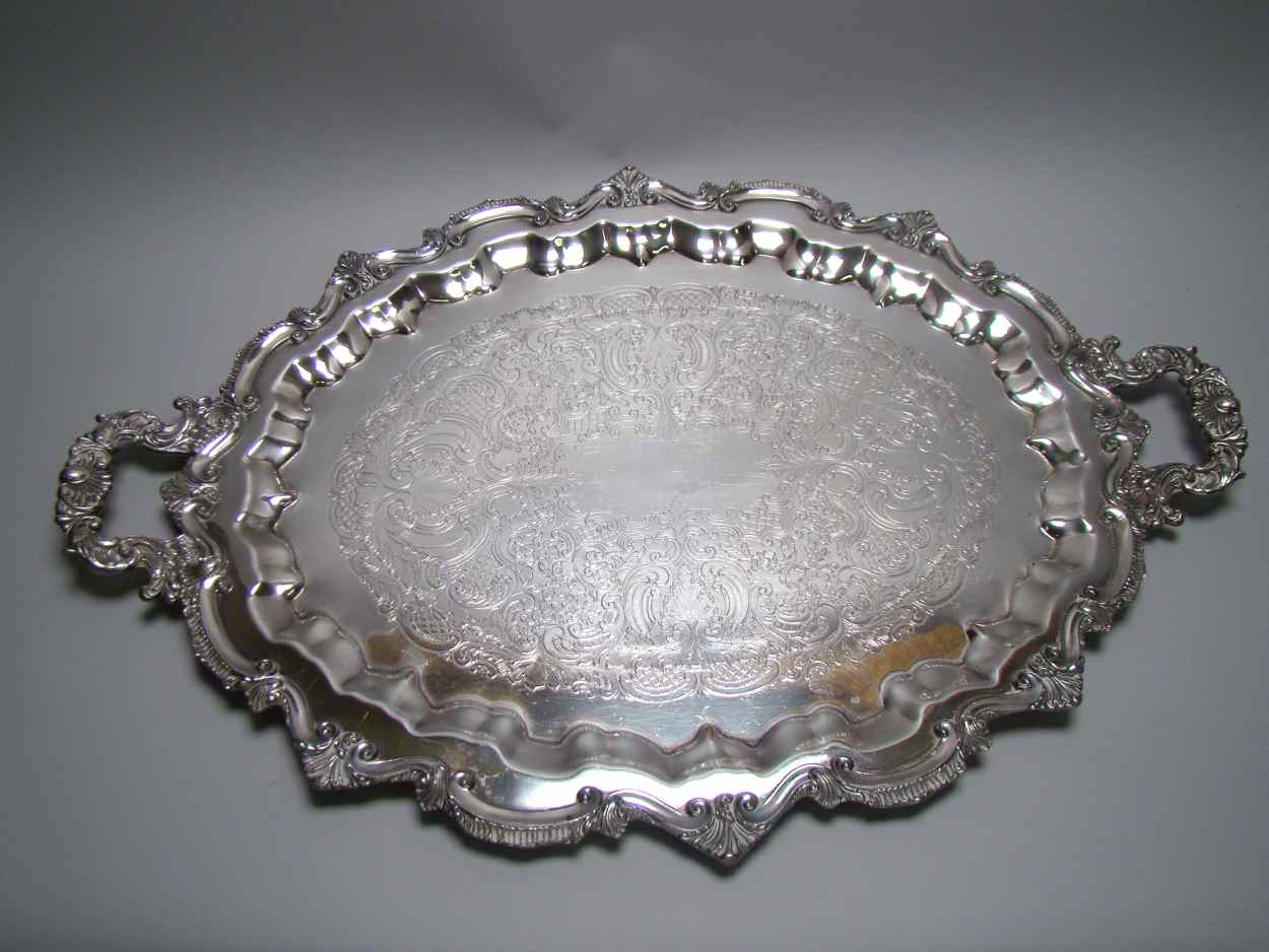 Appraisal: OVAL SILVER PLATED WAITER th CenturyWith heavy shell-design handles applied