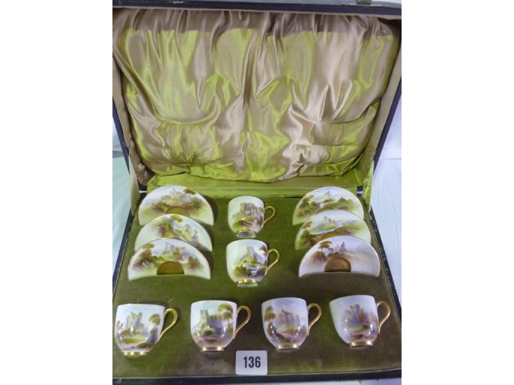 Appraisal: A cased Royal Worcester cabinet set in a green velvet