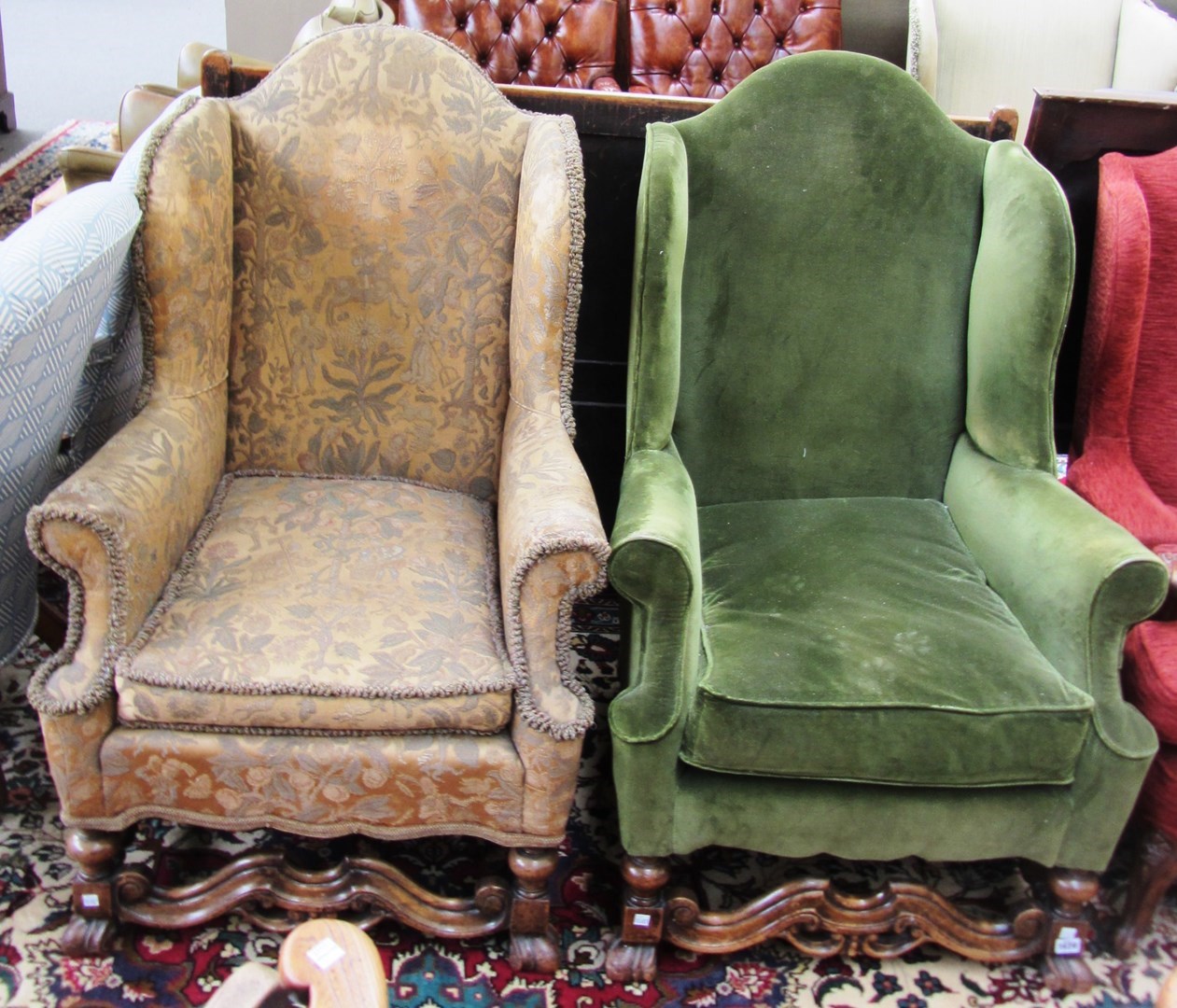 Appraisal: A pair of early th century mahogany framed wingback armchairs