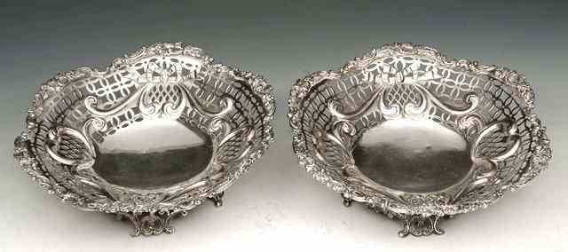 Appraisal: A PAIR OF VICTORIAN BASKETS with pierced foliate and ribbon