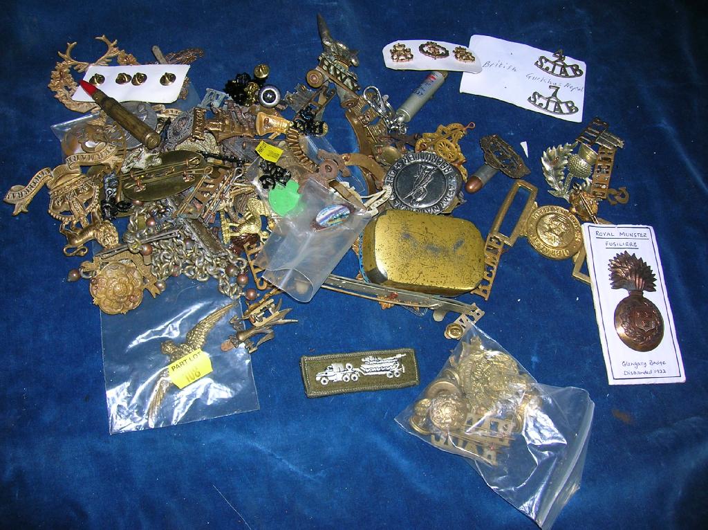 Appraisal: An assorted lot of cap badges buttons shoulder titles etc