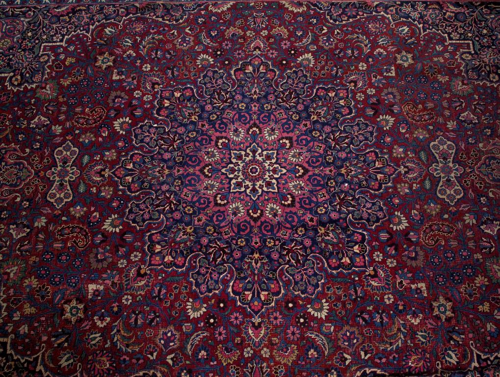 Appraisal: LARGE MESHED CARPET woven in shades of ivory red blue