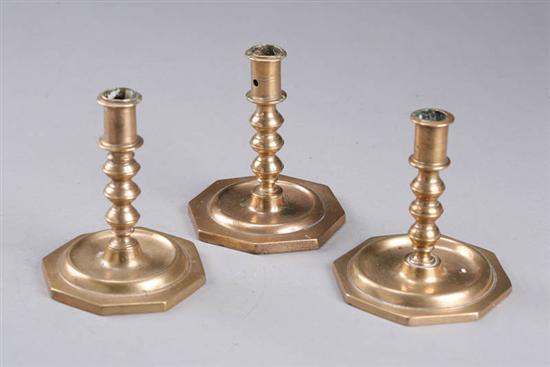 Appraisal: THREE CANDLESTICKS Probably Spanish late th century brass possibly bell