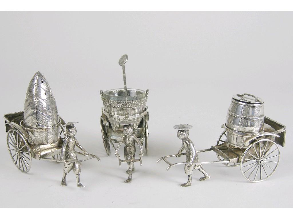 Appraisal: An oriental Condiment Set in the form of three rickshaws