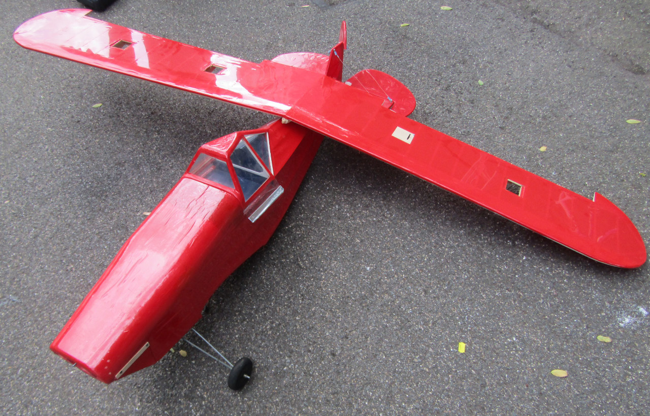 Appraisal: A remote controlled single propeller airplane in red cm long