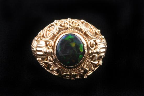 Appraisal: K YELLOW GOLD BLACK OPAL RING Oval opal cabochon bezel