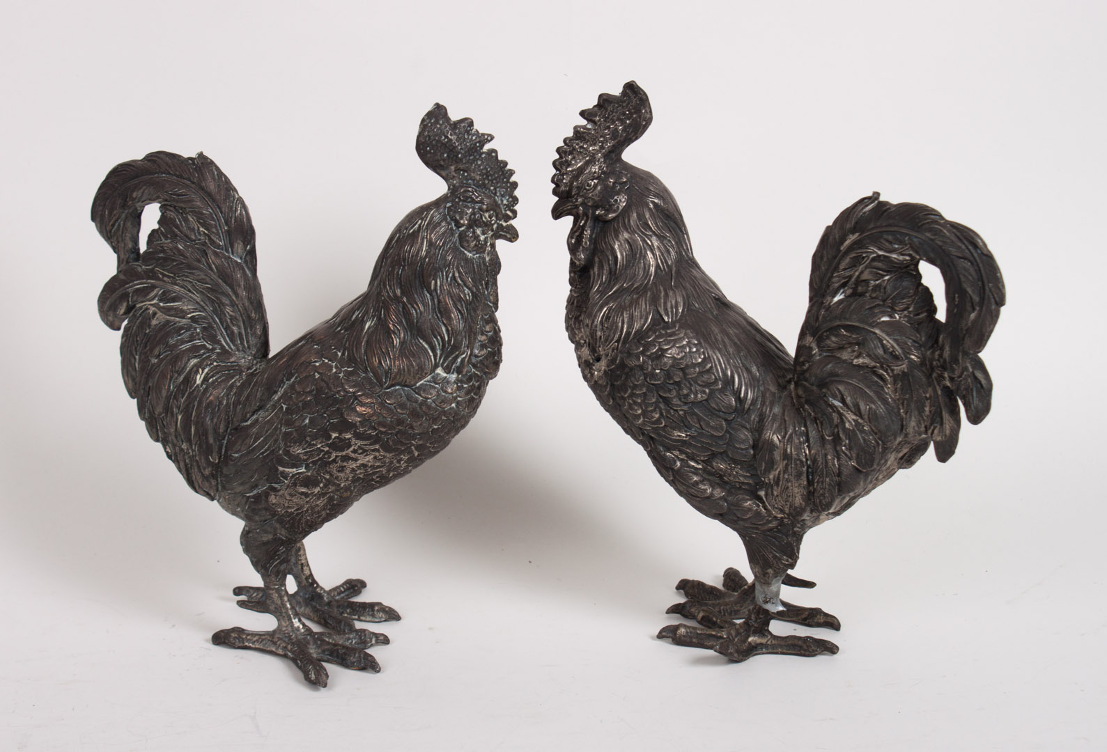 Appraisal: Pair of silver-plated roosters in H