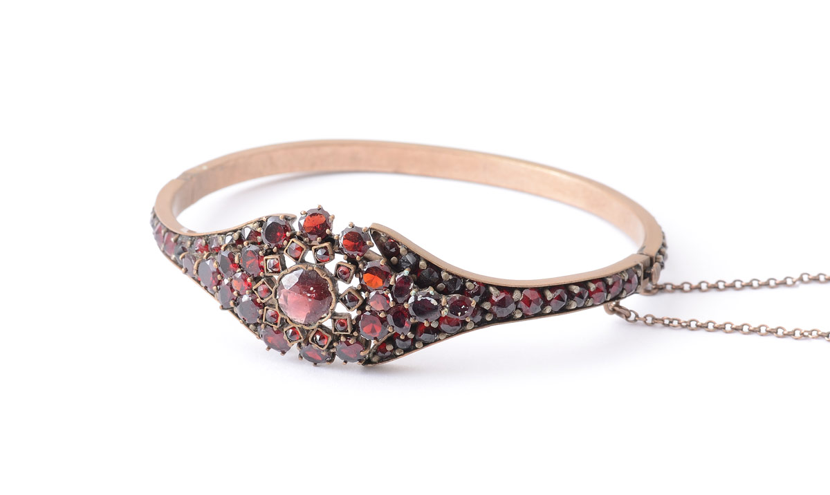 Appraisal: VICTORIAN ERA GARNET BANGLE BRACELET Hinged bracelet covered in faceted