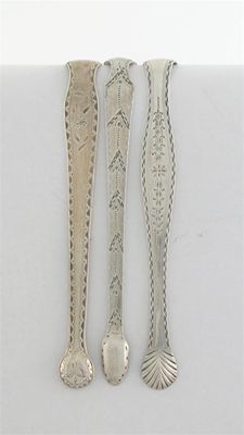 Appraisal: Three pairs of George III bright-cut tongs by various makers