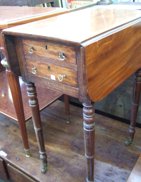 Appraisal: A Regency mahogany drop-flap side table with two frieze drawers