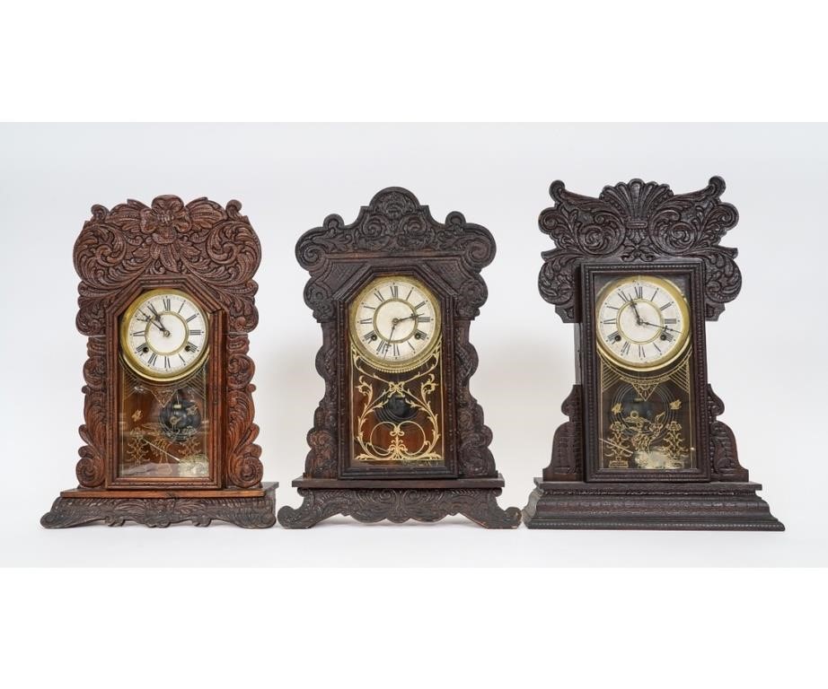 Appraisal: Three oak gingerbread clocks all by Waterbury Clock Company Tallest