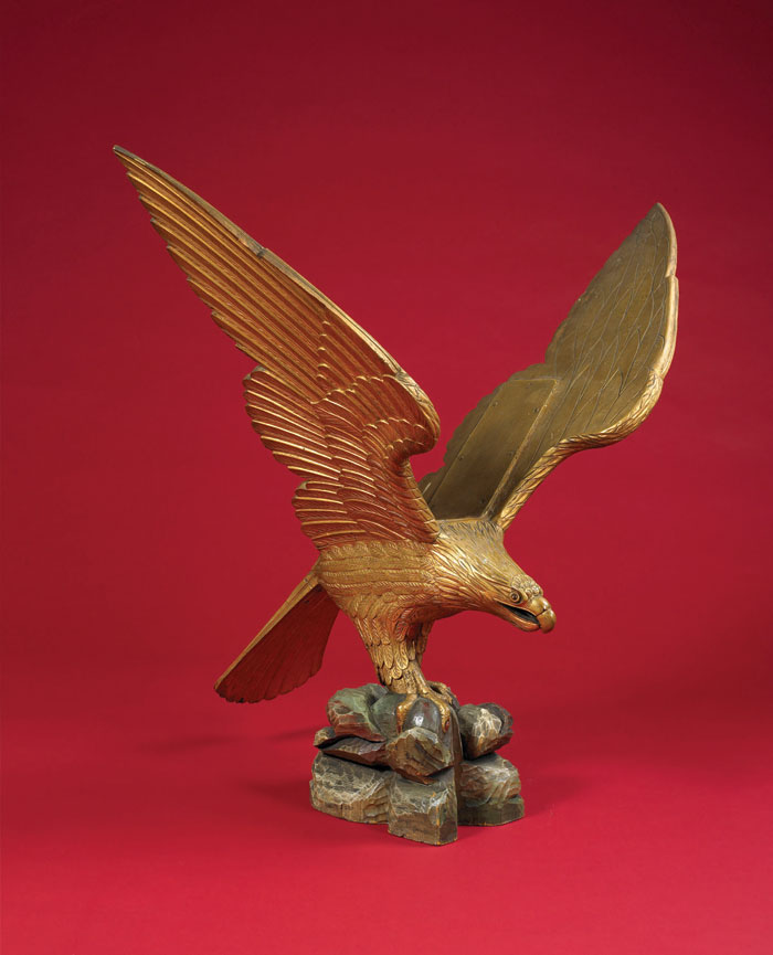 Appraisal: GILT AND CARVED PINE PILOT HOUSE EAGLE ON ROCKY PLINTH