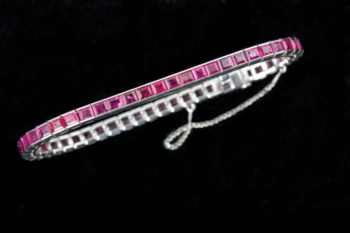 Appraisal: RUBY STRAIGHT LINE BRACELET The platinum bracelet set with fifty-two