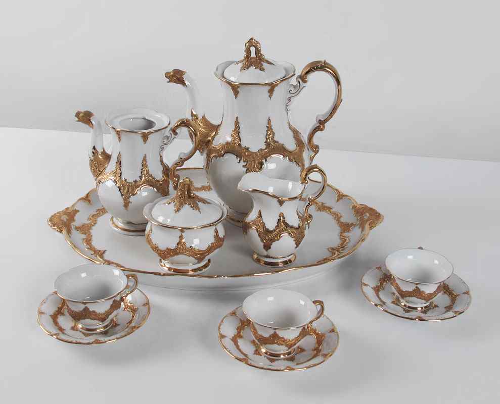 Appraisal: MEISSEN PORCELAIN CABARET SERVICE Gilt covered design in relief Includes