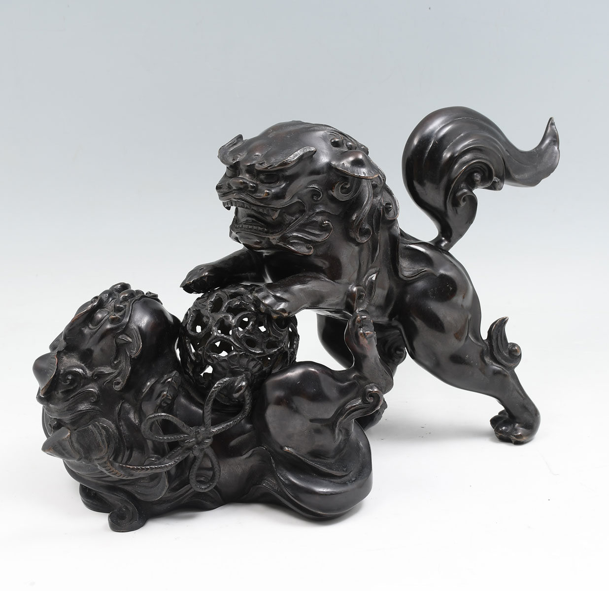 Appraisal: BRONZE FOO DOGS - Patinated bronze Foo Dogs playing with