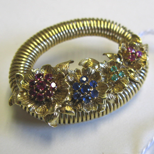 Appraisal: AN EIGHTEEN KARAT GOLD AND MULTI-COLOR GEMSTONE BASKET OF FLOWERS