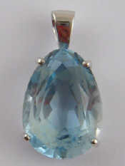 Appraisal: A white metal tests carat gold blue topaz pendant the