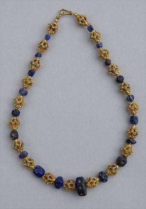 Appraisal: PERSIAN GOLD AND LAPIS NECKLACE Strand of hollow filigree round