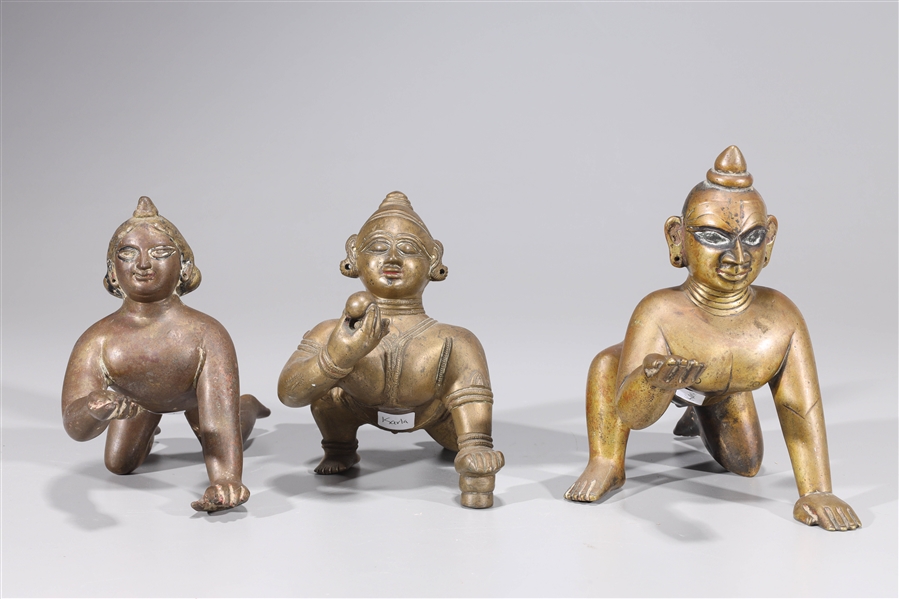 Appraisal: Group of three antique Indian crawling Bala Krishna statues in