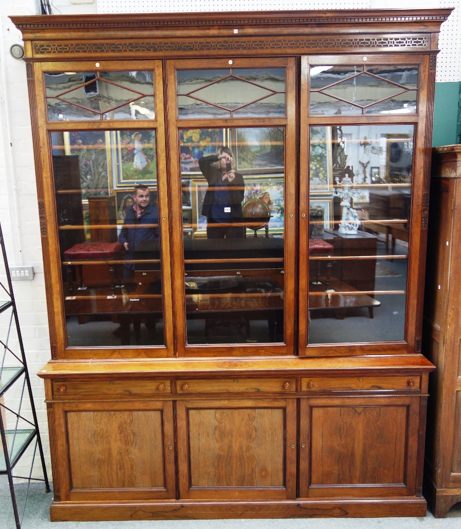 Appraisal: A Victorian rosewood bookcase cupboard with three glazed doors over