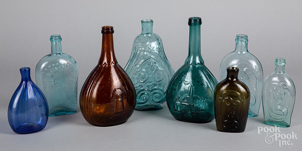 Appraisal: Colored glass bottles and historic flasks Colored glass bottles and