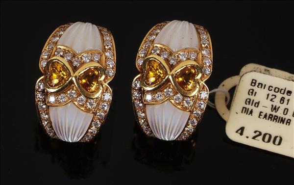 Appraisal: A pair of multi gem set ear clips the central