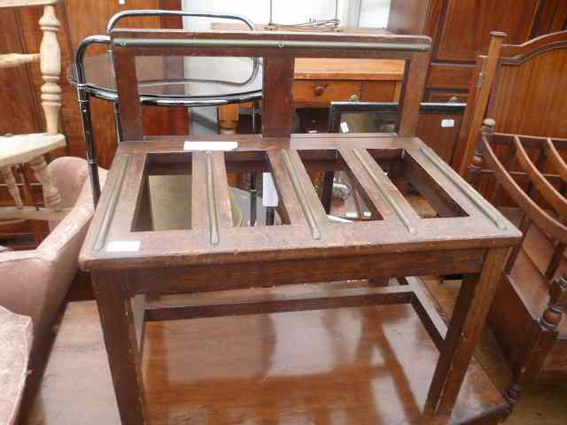 Appraisal: A MAHOGANY AND BRASS BOUND LUGGAGE RACK with raised back