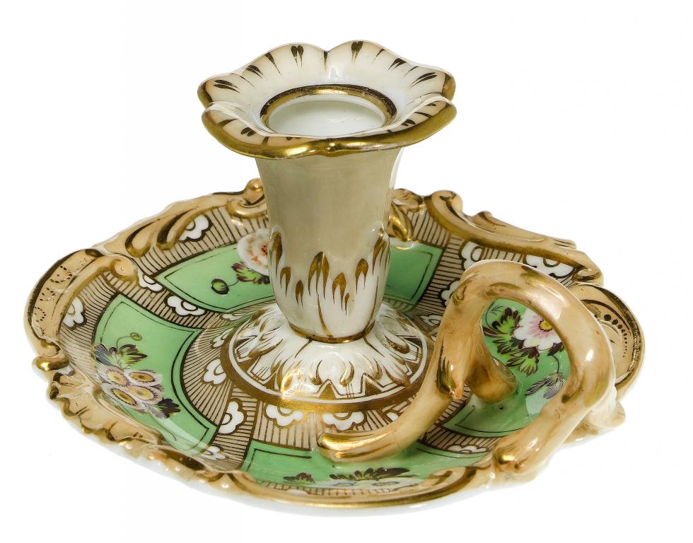 Appraisal: A STAFFORDSHIRE CHAMBERSTICK the panelled apple green ground painted with