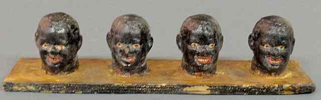 Appraisal: Set of four folk art carved heads of black men