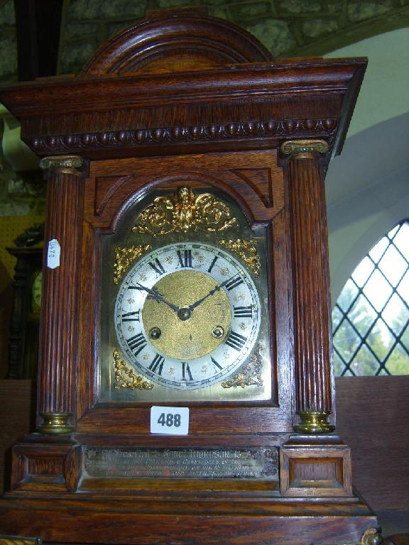 Appraisal: An Edwardian oak bracket clock with ionic column supports enclosing