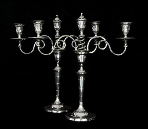 Appraisal: A pair of Sheffield plated two-branch three-light candelabra each with