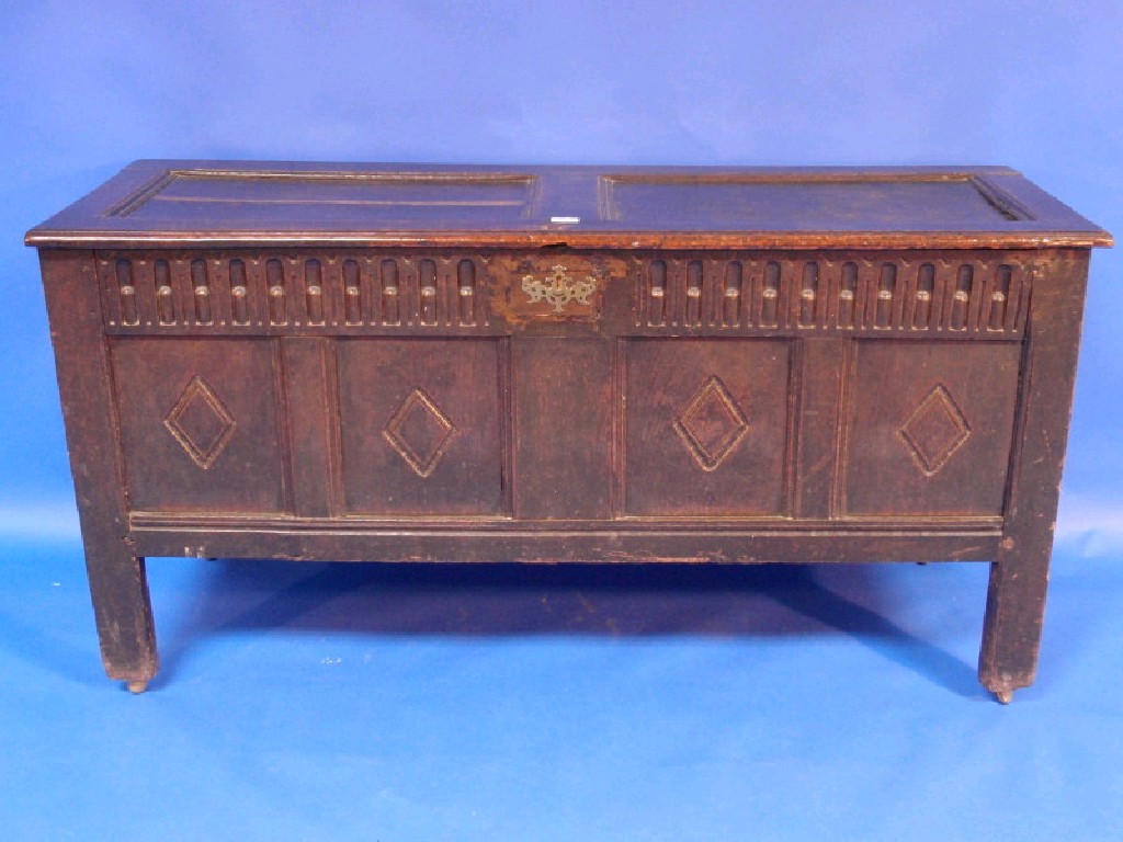 Appraisal: A thC oak coffer with two panel top scoop carved