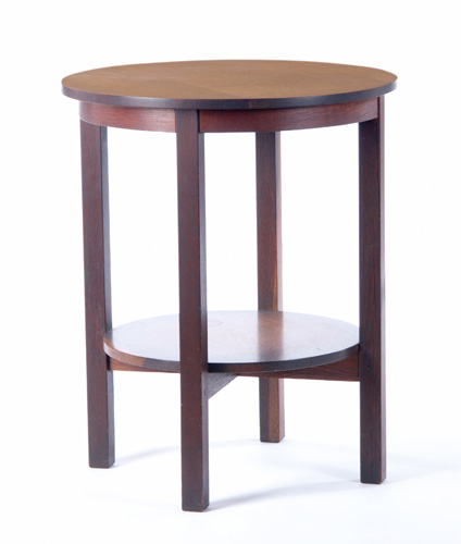 Appraisal: GUSTAV STICKLEY Lamp table with a circular top apron and