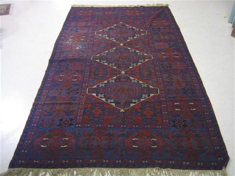 Appraisal: MODERN DARK RED AND BLUE RUG ' x '