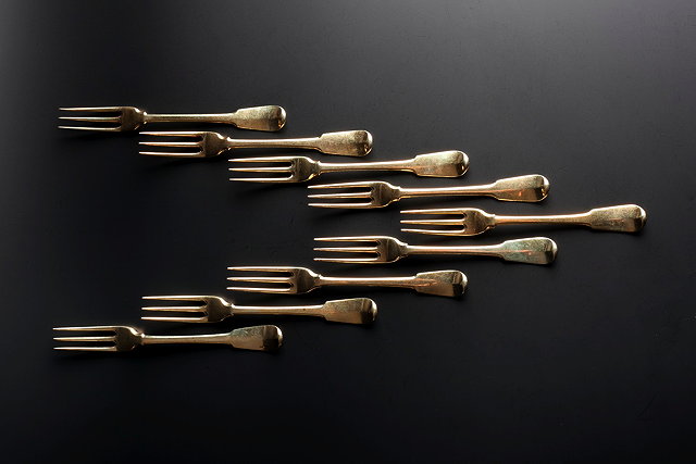 Appraisal: A SET OF NINE SILVER GILT THREE PRONG FIDDLE PATTERN