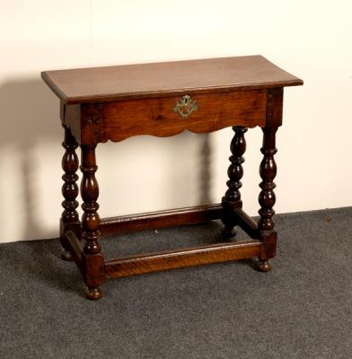 Appraisal: An oak table with shaped frieze on baluster turned legs