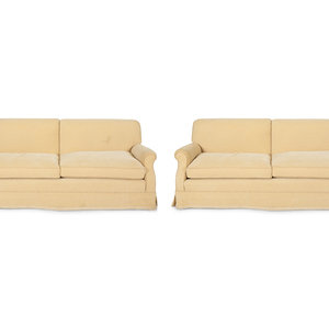 Appraisal: A Pair of Ivory Upholstered Three Cushion Sofas th Century