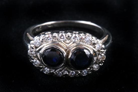 Appraisal: K WHITE GOLD AND SAPPHIRE RING Pair bezel-held round sapphires