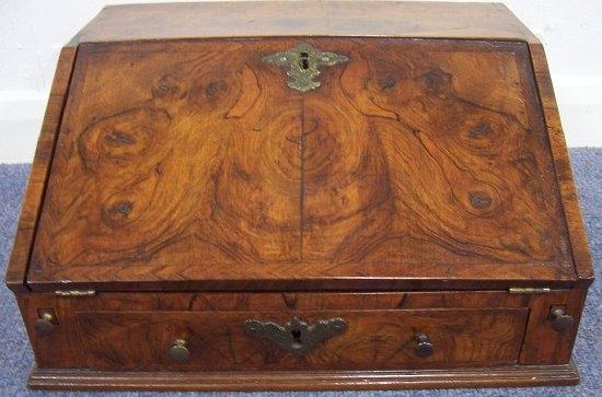 Appraisal: A walnut table bureau of Queen Anne design the interior