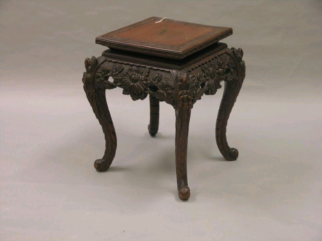 Appraisal: A Chinese carved wood jardiniere stand boldly carved apron of